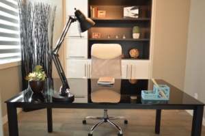 home office with work desk lamp chair and bookcase