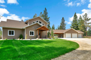 single detached home with garage, green grass
